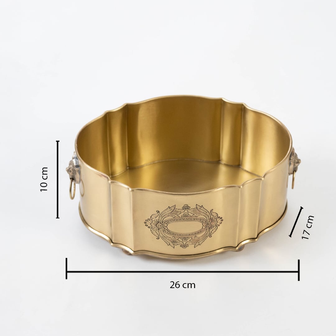 Round gold brass container shown with 30 cm width 12 cm height and 17 cm depth including lion head ring handles.