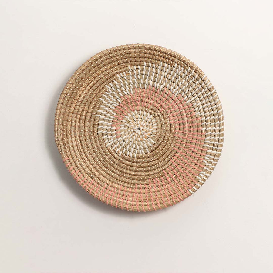 Natural and terracotta woven decorative wall basket with spiral pattern for elegant wall styling and modern home decor.