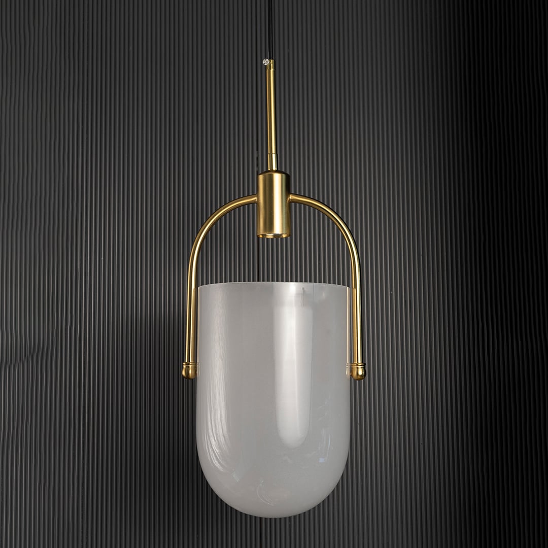 Elegant gold and white pendant light turned off with soft frosted glass shade and metallic gold structure shown against a black background.