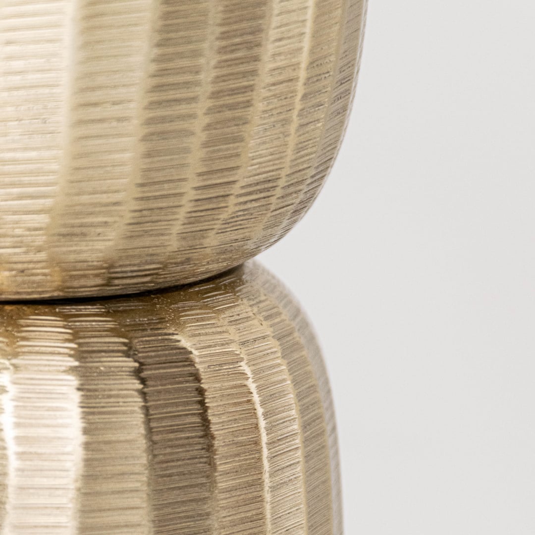 Closeup of gold metal decorative stand showing detailed textured surface and refined shape ideal for modern elegant interior styling.