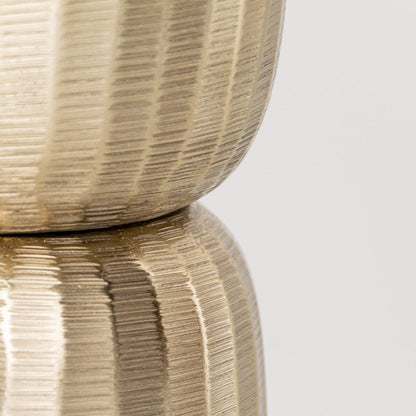 Closeup of gold metal decorative stand showing detailed textured surface and refined shape ideal for modern elegant interior styling.