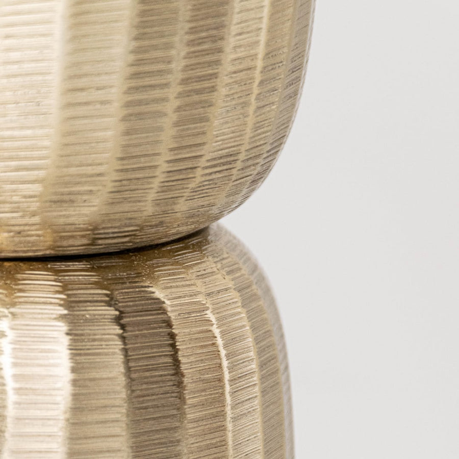 Closeup of gold metal decorative stand showing detailed textured surface and refined shape ideal for modern elegant interior styling.