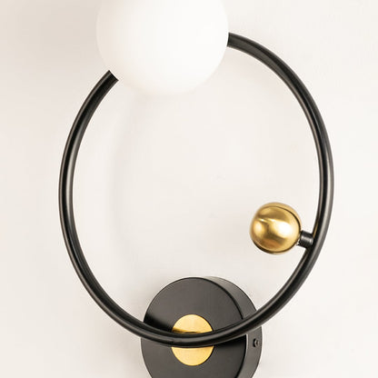 Modern black and gold circular wall light with white globe designed for stylish décor and ideal for hallways and living rooms in contemporary interiors.