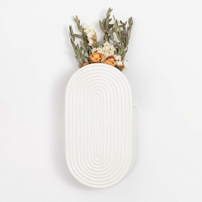 White ceramic wall vase with textured oval design shown against a clean background for modern home decor styling.