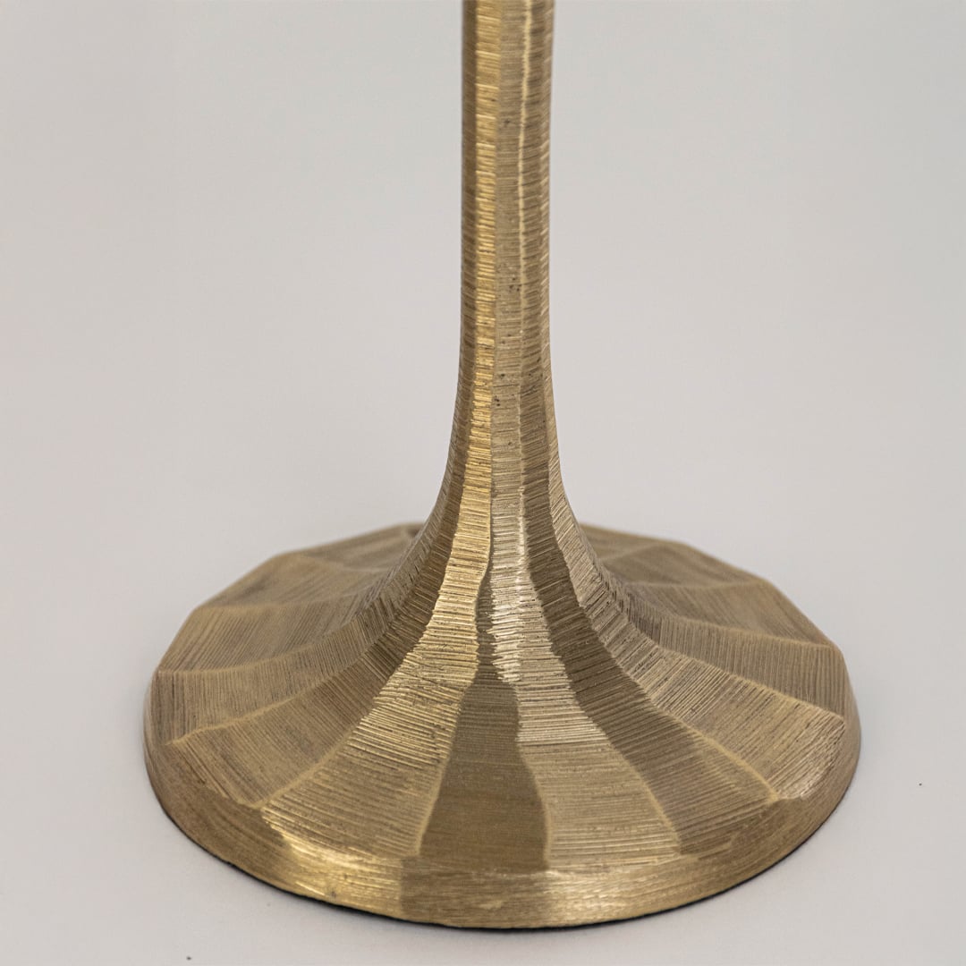 Closeup view of gold metal lamp base with sculpted form highlighting smooth finish solid build and elegant decorative appeal.