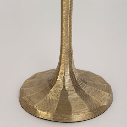 Closeup view of gold metal lamp base with sculpted form highlighting smooth finish solid build and elegant decorative appeal.