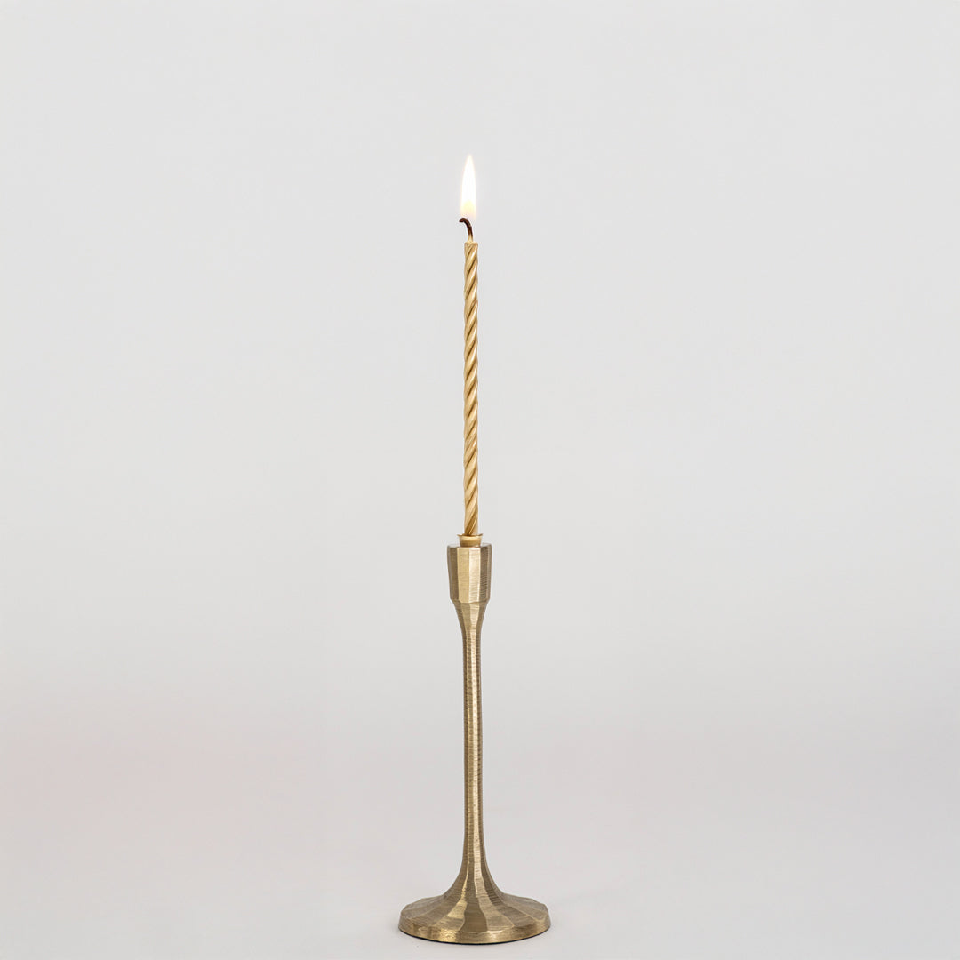 Elegant metal candle holder in gold finish with tall slender design for table decor or dining styling modern home placement white background.