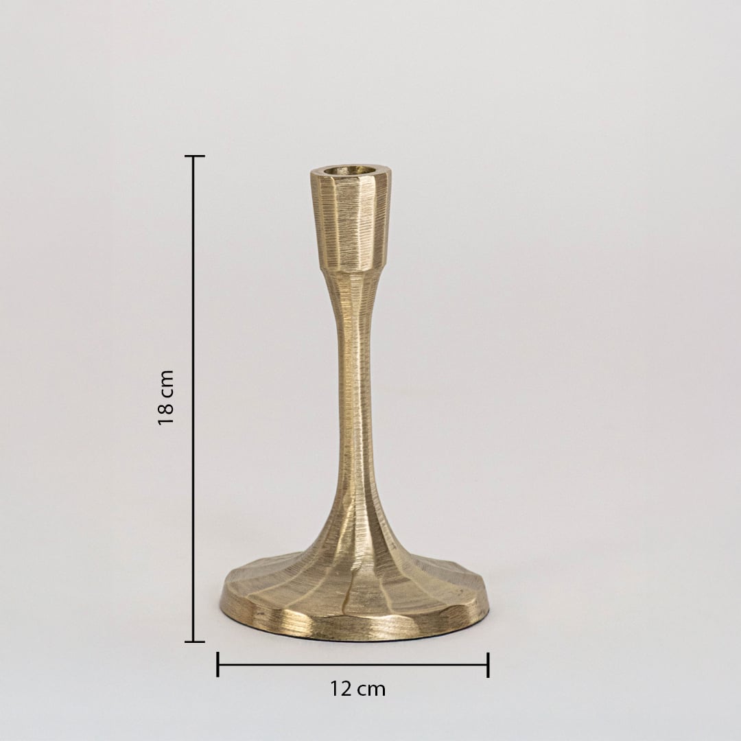 Gold candle holder with elegant narrow stem and faceted base measuring 18 cm tall and 12 cm wide on white surface