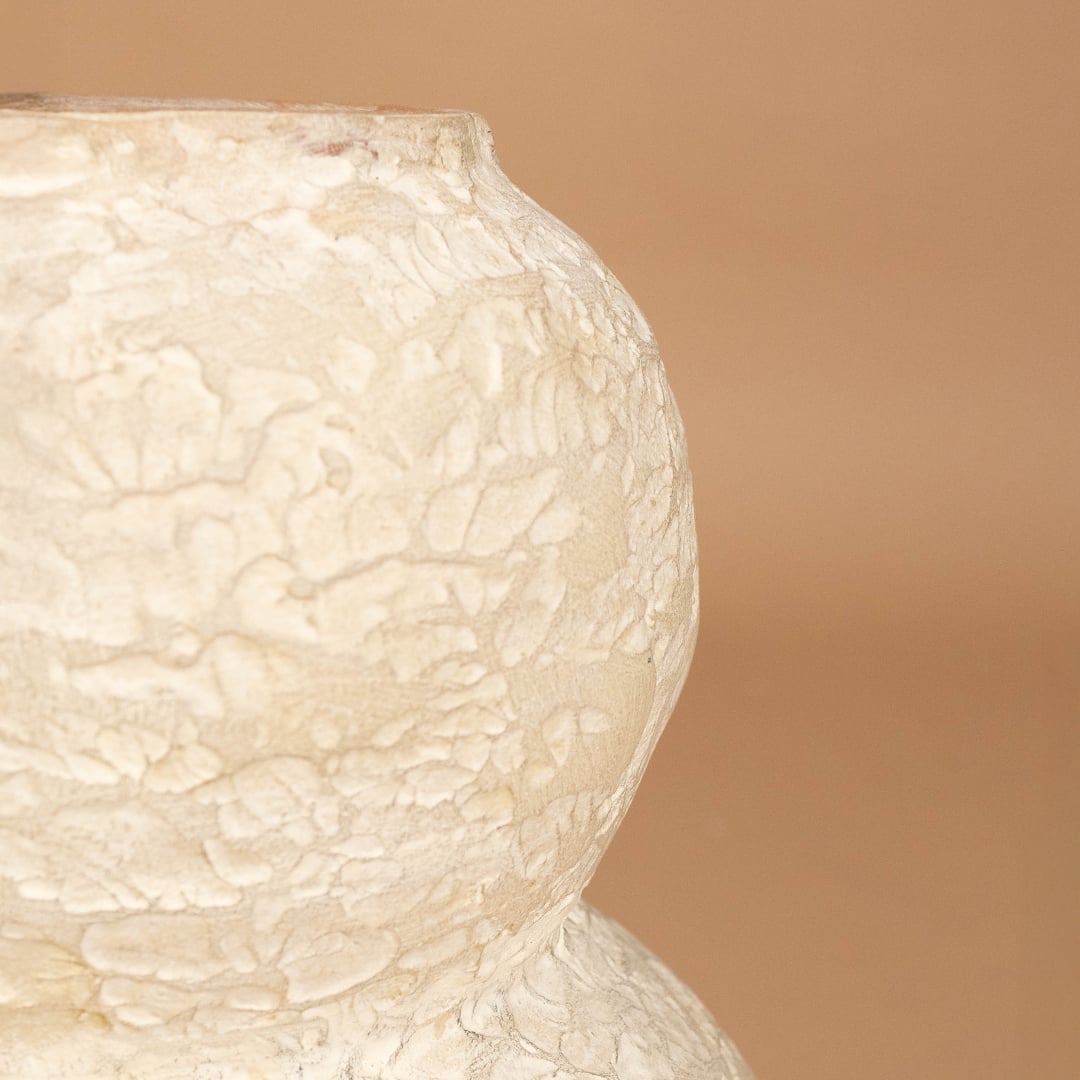 Closeup of cream textured decorative vase showing detailed handcrafted texture and sculpted form ideal for artistic modern home decor.