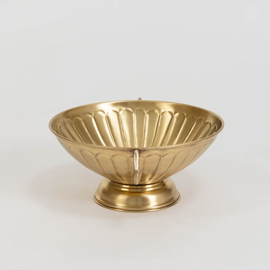 Decorative gold metal fruit bowl with twin ornate handles and fluted texture displayed on plain white background.