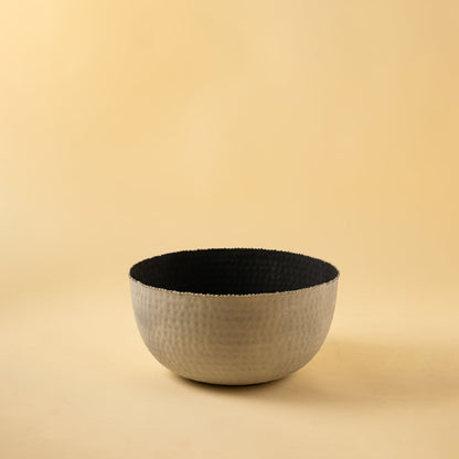 Hammered grey metal bowl with black interior displayed on a clean white background highlighting its modern finish.