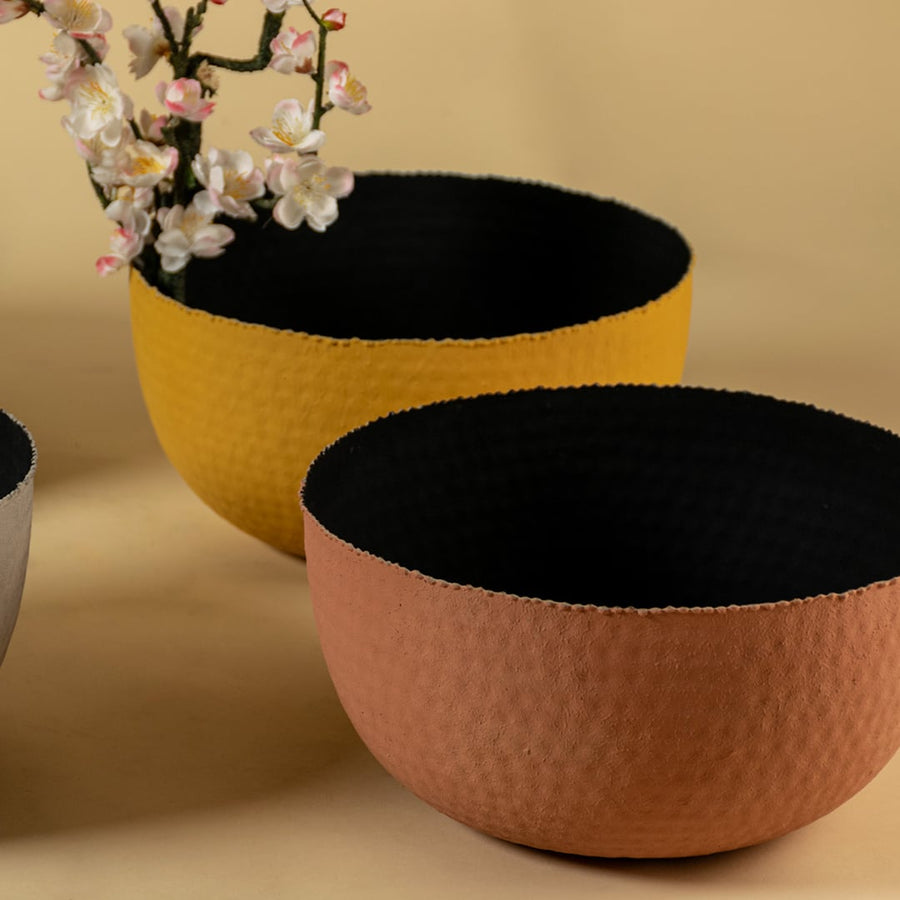 Closeup of black hammered metal bowl showing textured detailing and matte finish for a bold modern decor accent.