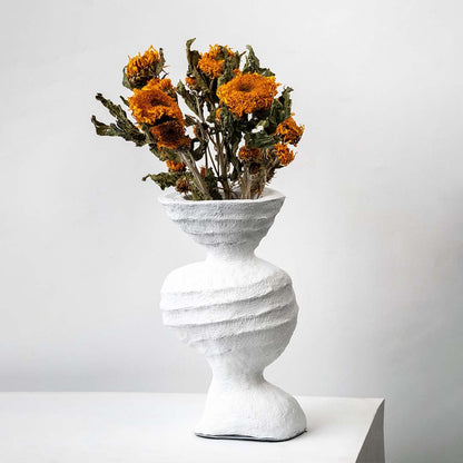 Bright orange dried marigold bunch held in hand adding warm rustic charm to a natural modern home decor setting.