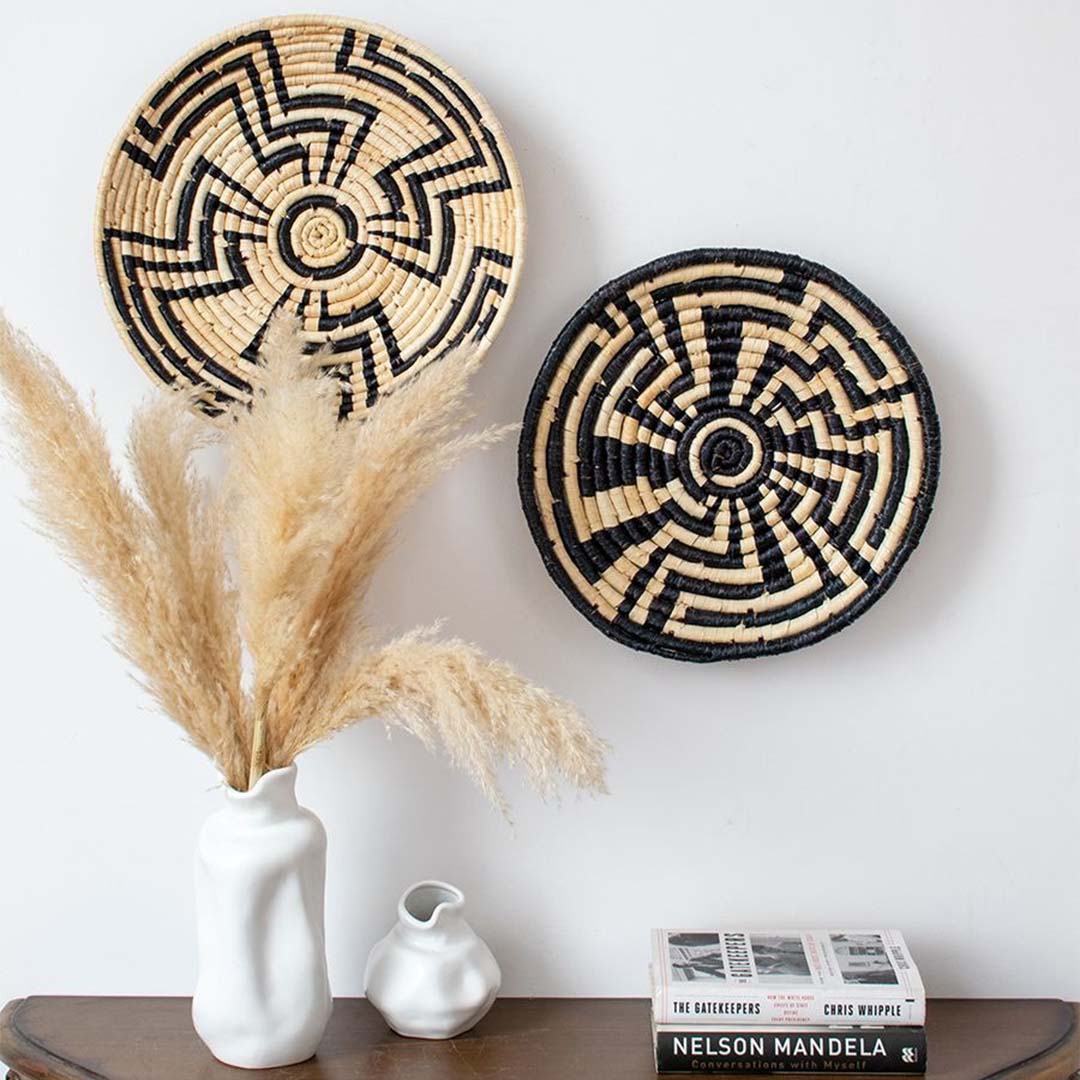 Large black and beige wall basket used as statement wall décor in contemporary living room.
