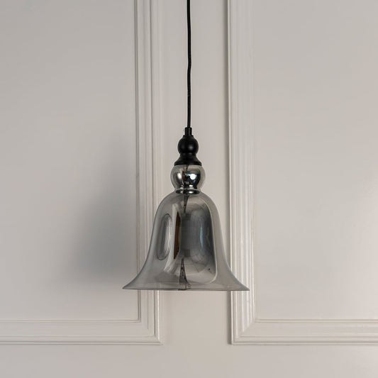 Transparent smoky glass pendant light with black metal hardware crafted for stylish interior settings.