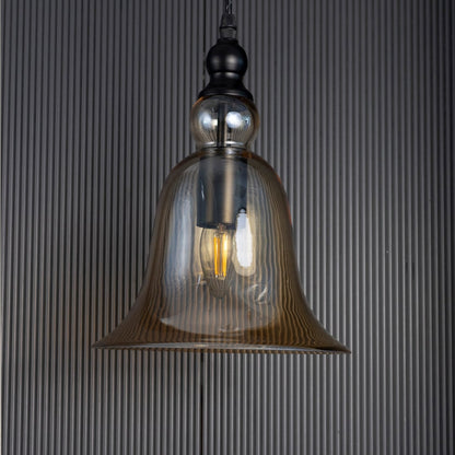Sleek amber glass hanging light fixture turned off isolated on a pitch black background for a dramatic high contrast style.