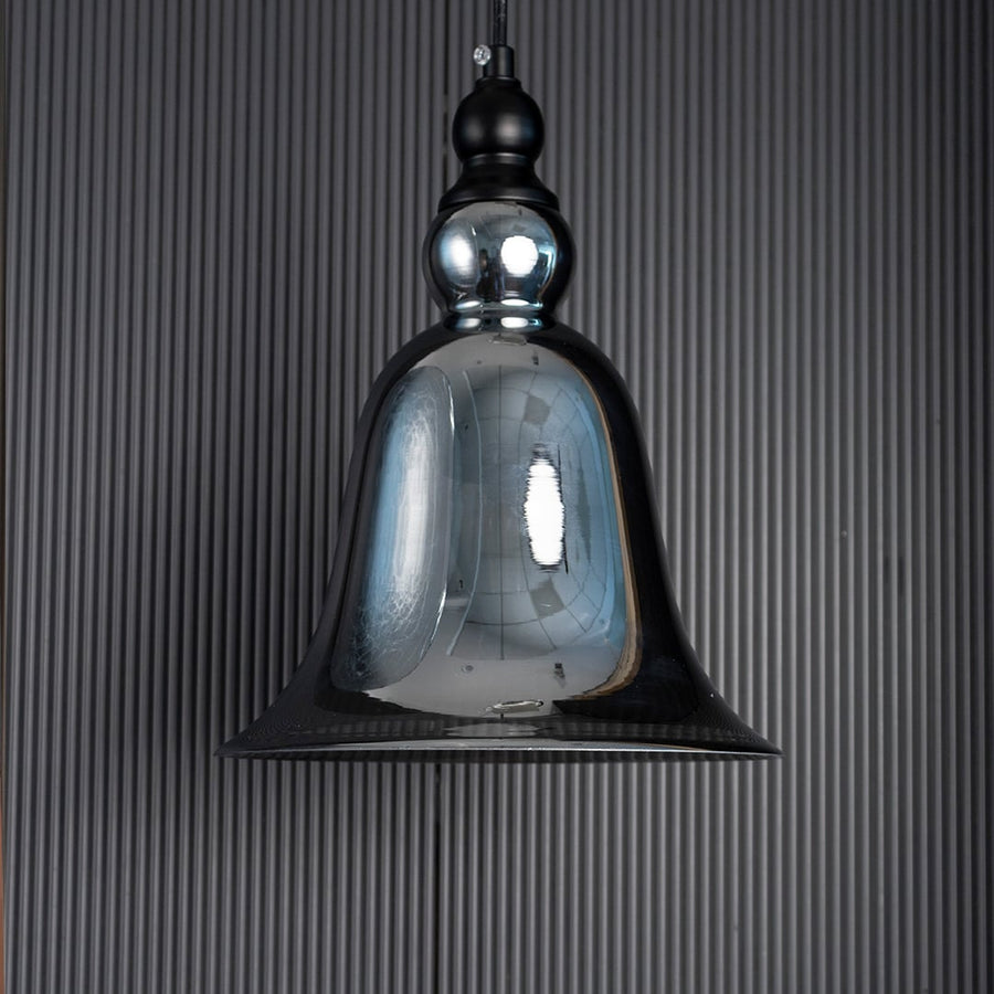 Sleek smoke grey glass hanging light fixture turned off isolated on a pitch black background for a dramatic high contrast look.