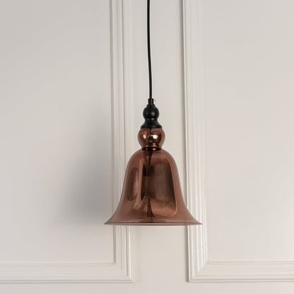 Illuminated black metal pendant light with ribbed amber glass shade creating a cozy glow.
