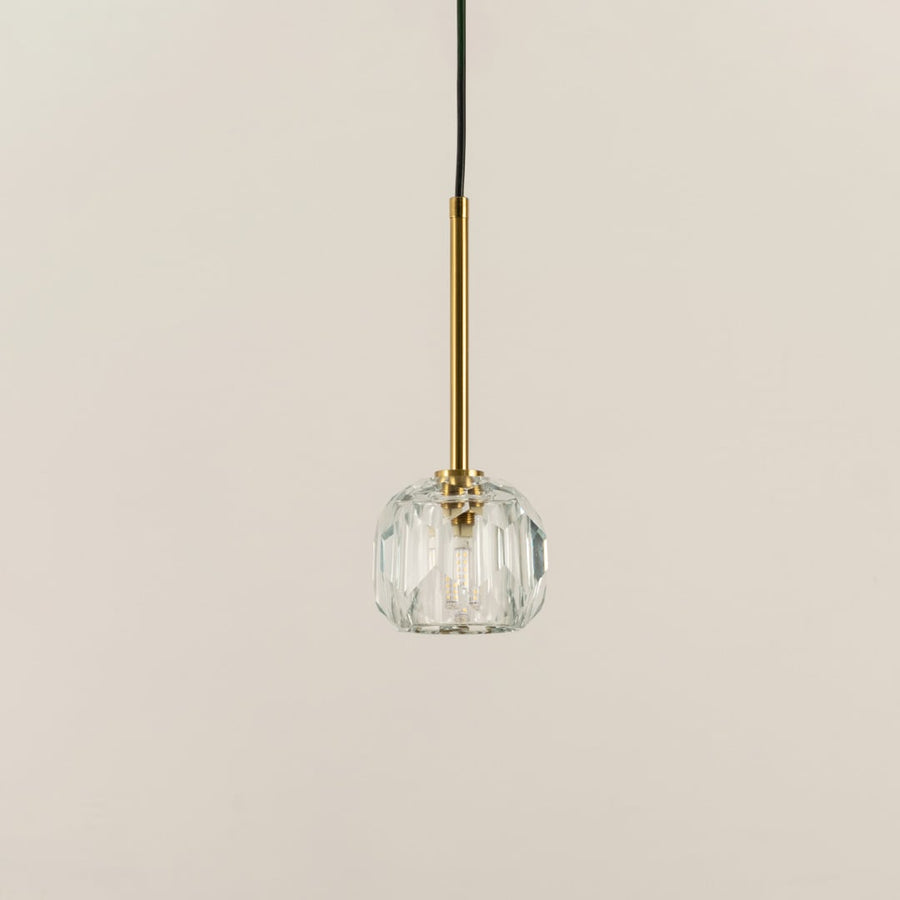Clear faceted glass pendant light with polished gold accents crafted for elegant living spaces.