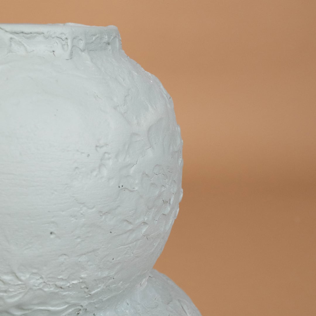 Closeup of light blue textured decorative vase showing intricate sculpted detailing and modern handcrafted finish ideal for artistic home decor.