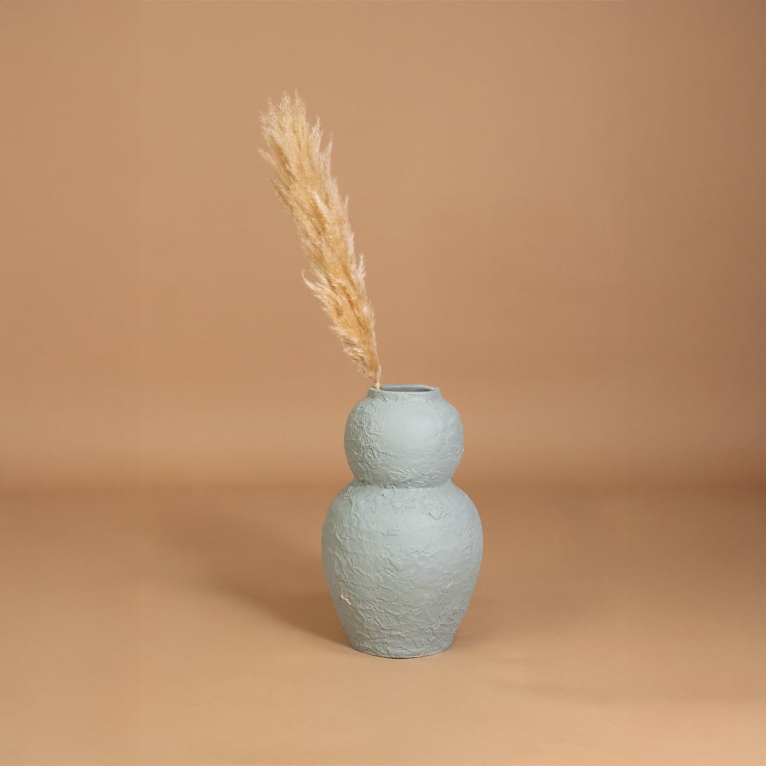 Light blue textured decorative vase placed in a curated home setting enhancing shelves consoles and living spaces with modern artistic decor.