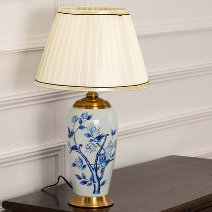 Blue and white ceramic table lamp with a cream pleated shade maintaining decorative charm even when unlit perfect for luxury home decor.