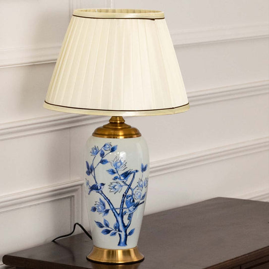 Blue and white ceramic table lamp with a cream pleated shade maintaining decorative charm even when unlit perfect for luxury home decor.