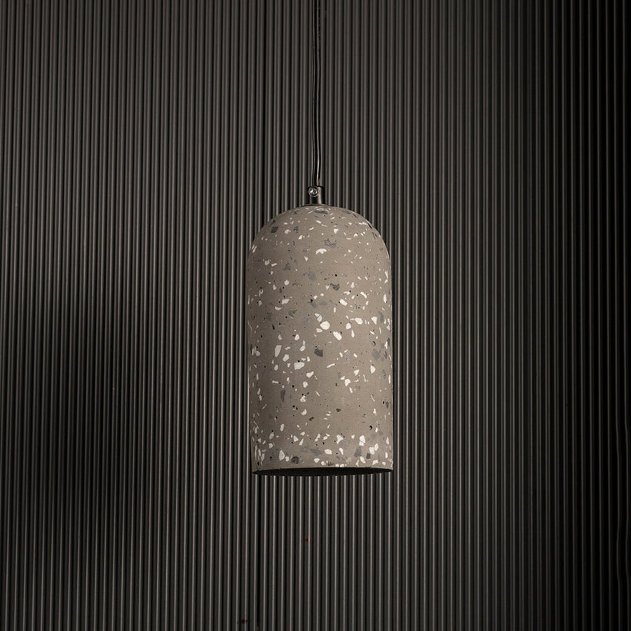 Warm terrazzo pendant light turned off highlighting its grey textured surface against a dark background for a modern industrial look.