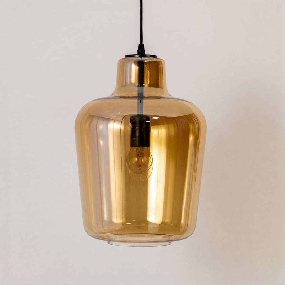 Amber glass pendant light turned off on a white background showing its clean reflective finish and smooth rounded design