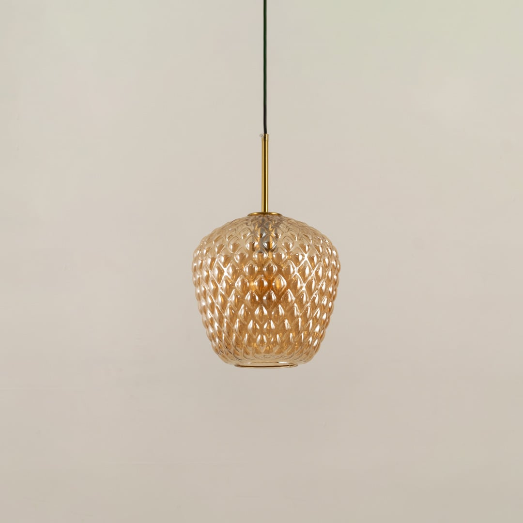 Amber textured glass pendant light shown with light off on a white background emphasizing its detailed surface pattern and modern rounded shape.