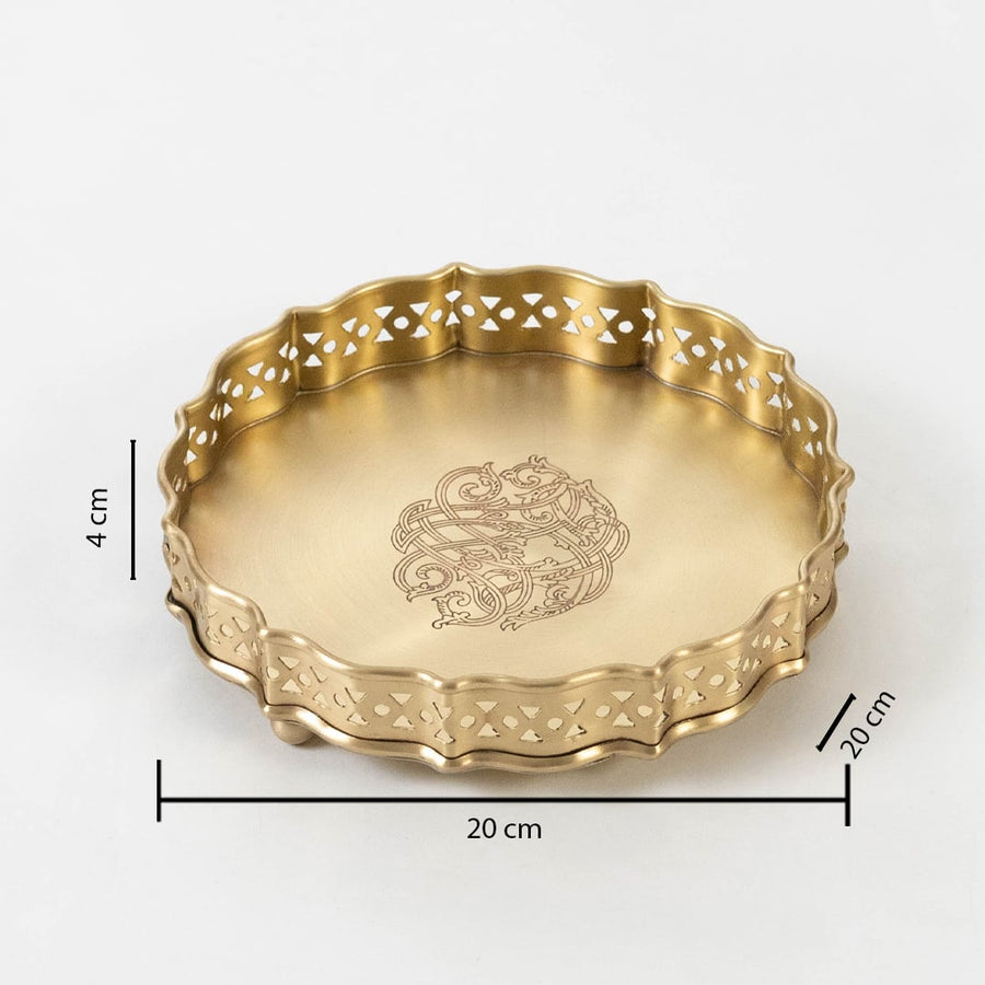 Round gold brass plate with floral center design shown with dimensions 20 cm diameter and 4 cm height on white.