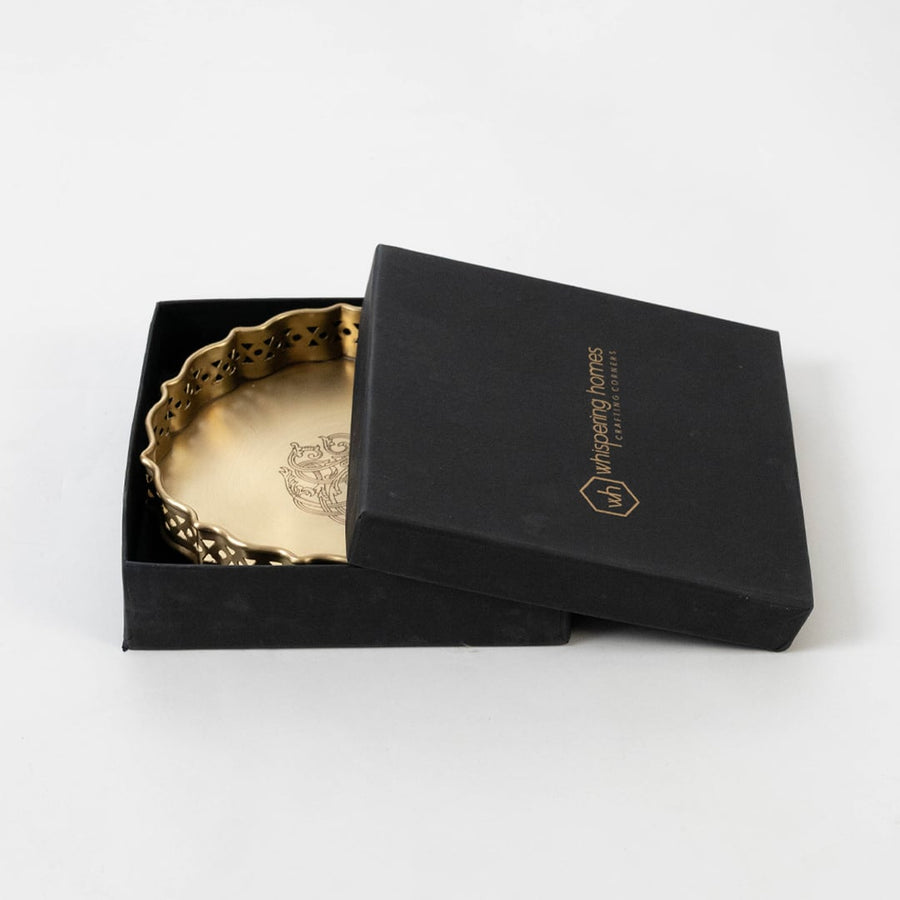Gold brass plate with floral pattern packed in black premium box with logo branding shown on clean white surface.