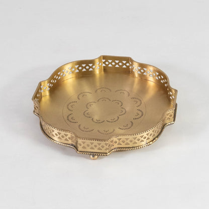 Gold finish brass plate with floral detailing and scalloped edges displayed on a clean white background surface.