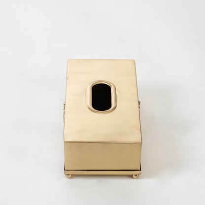 Gold metal tissue holder with 25 cm length 13 cm width and 9 cm height shown with engraved motif and foot base.