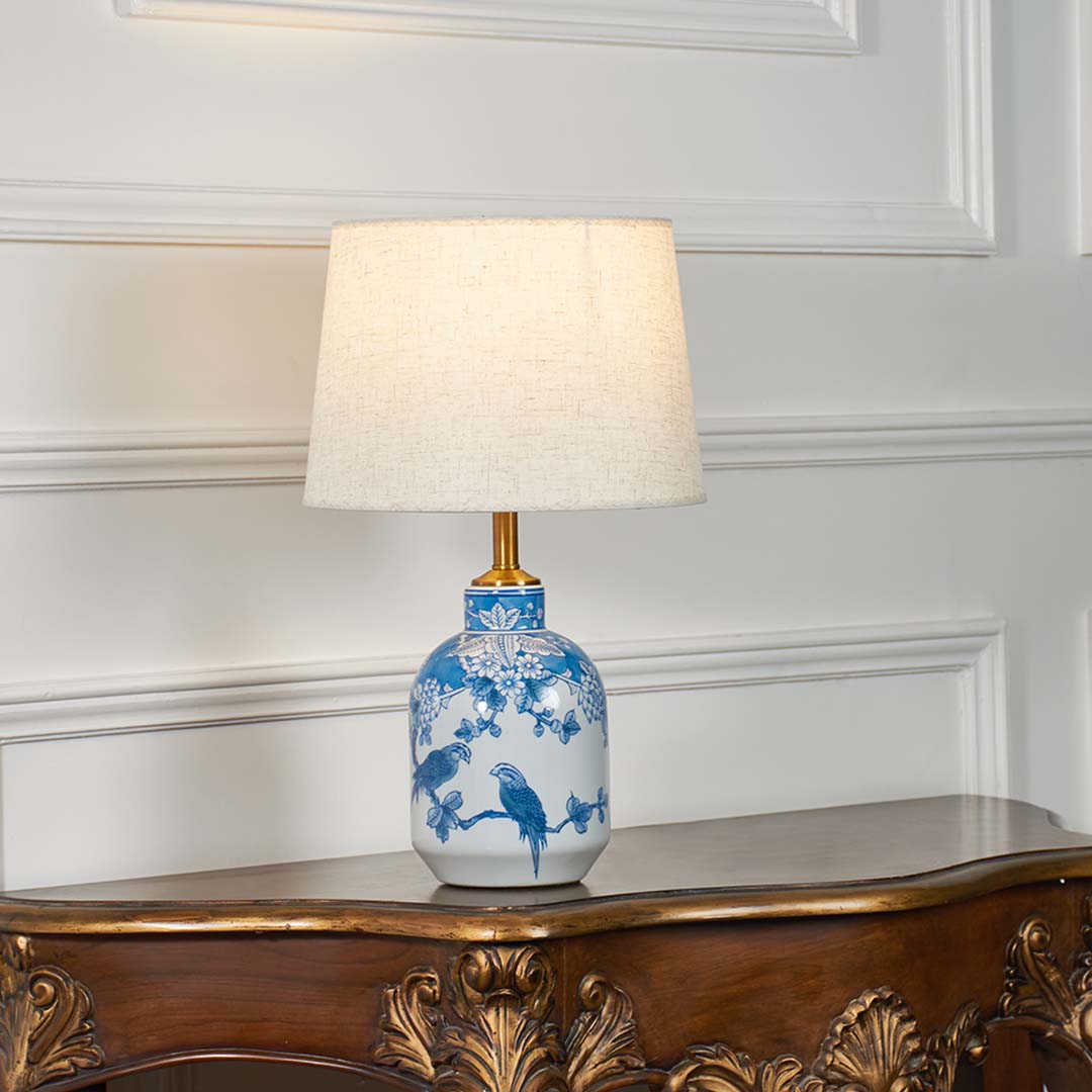 Blue and white floral ceramic table lamp with fabric shade designed for elegant traditional decor and ambient lighting.