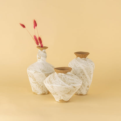 Set of rustic white and brown ceramic vases displayed together creating a warm organic and artisanal home styling look.