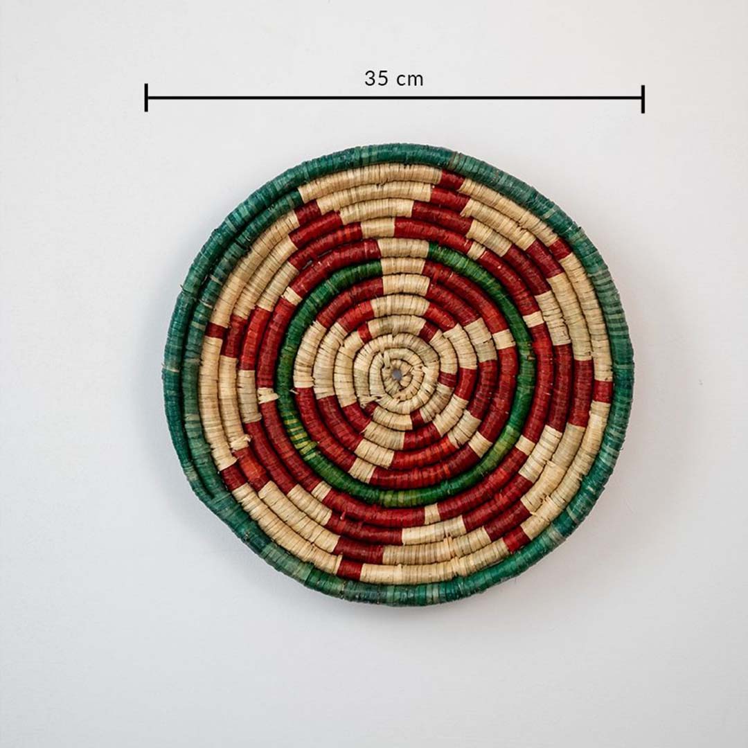 Handwoven jute round wall basket decor in beige red and green rustic boho style spiral wall art piece with 35 cm size shown.