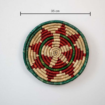Handwoven jute round wall basket decor in beige red and green rustic boho style spiral wall art piece with 35 cm size shown.