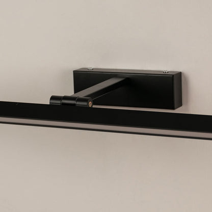 Closeup of black metal picture light showing slim bar design smooth finish and warm directional illumination.