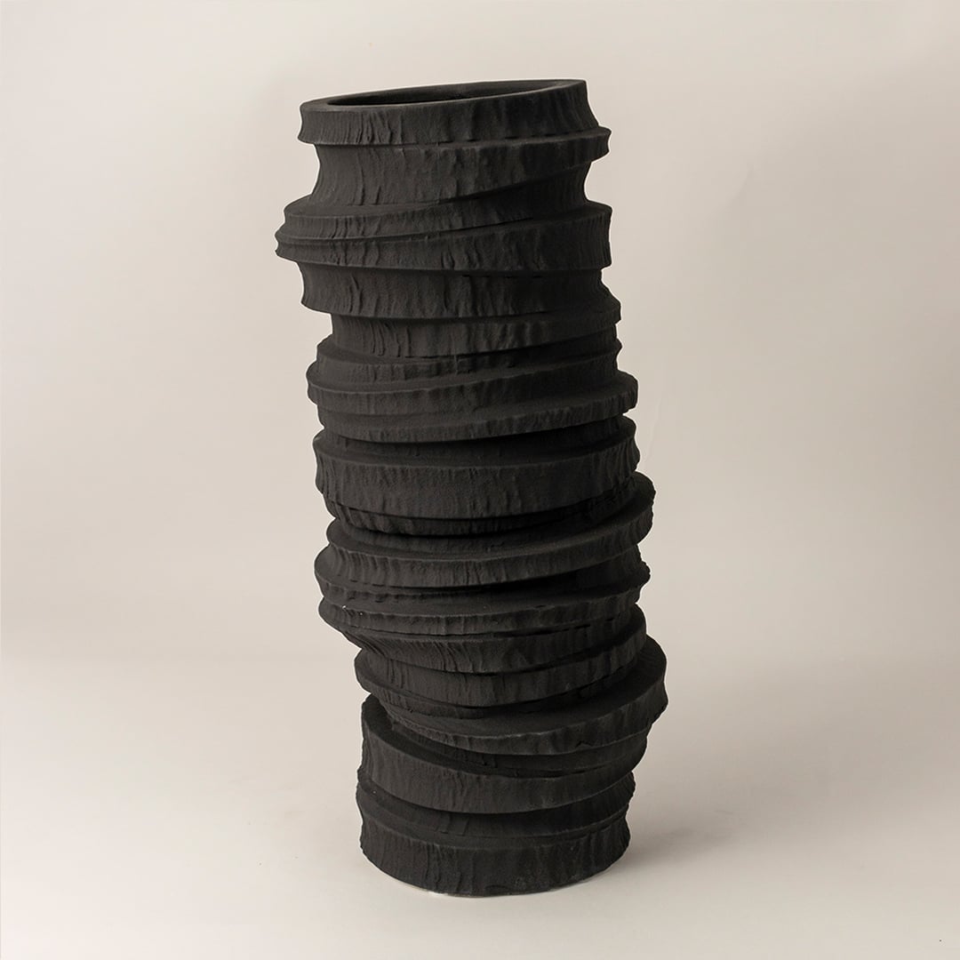 Side view of Onyx black ceramic vase highlighting its uneven ridged profile and sculptural handcrafted artistry for modern decor.