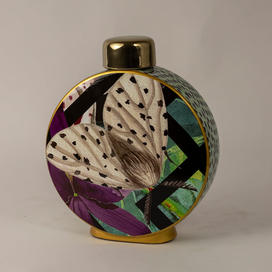 Butterfly ceramic jar against a white background emphasizing its vivid butterfly design and polished golden top.