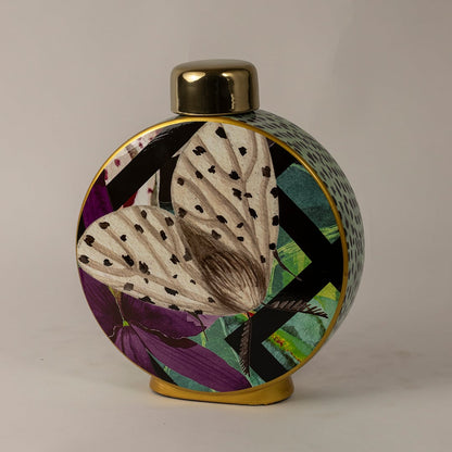 Butterfly ceramic jar against a white background emphasizing its vivid butterfly design and polished golden top.