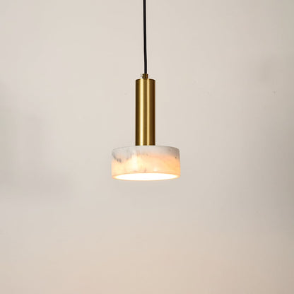 Gold metal pendant light with frosted glass diffuser illuminated to showcase modern ceiling lighting and warm glow.