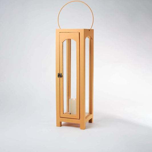 Glowing wooden garden lantern with a flickering candle inside on a white background creating a dramatic warm lighting contrast effect.