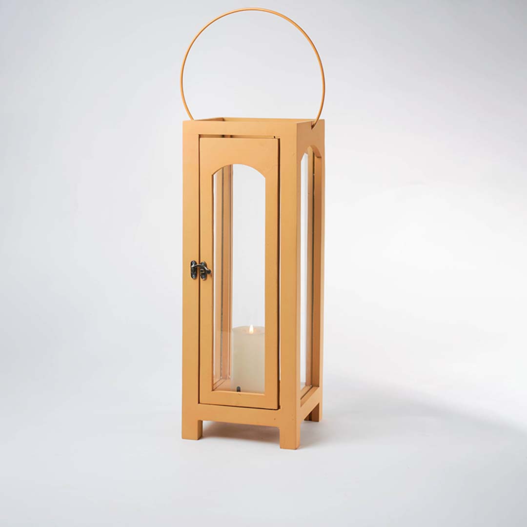 Wooden lantern with arch glass panels and round handle for rustic tabletop decor styling use.