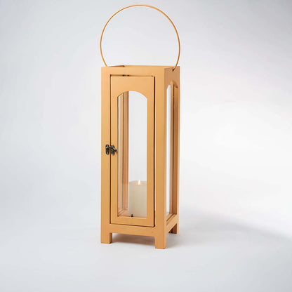 Wooden lantern with arch glass panels and round handle for rustic tabletop decor styling use.