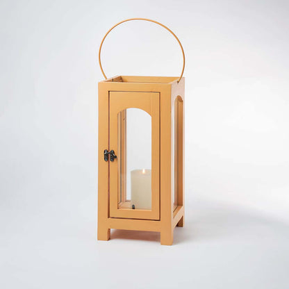 Illuminated blue ribbed glass pendant light turned on glowing warmly against a clean white background to highlight the textured glass design.