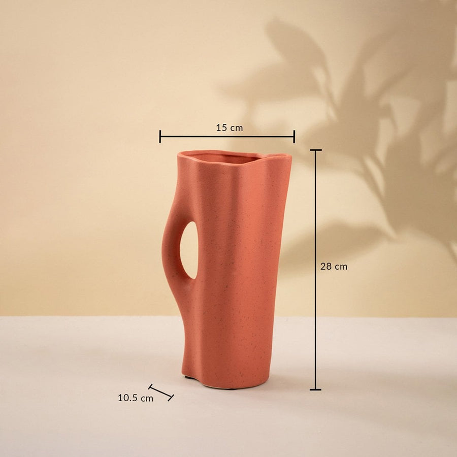 Terracotta ceramic vase measuring 28 cm in height and 15 cm in width featuring an artistic hollow detail and curved organic structure.