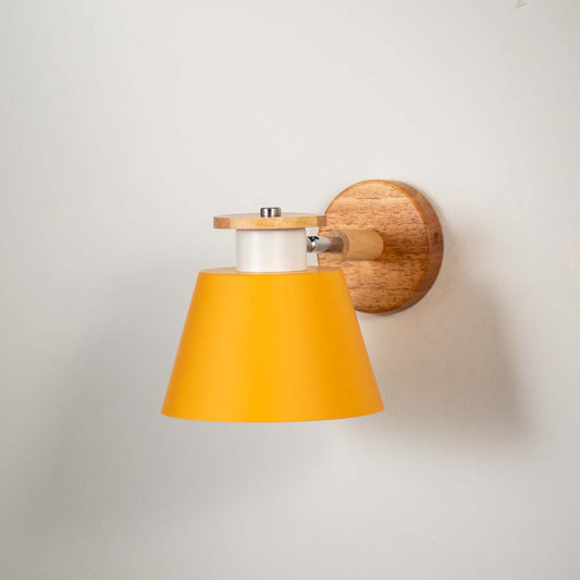 Closeup of mustard metal and wooden wall light for modern bedroom and elegant decor styling spaces.

