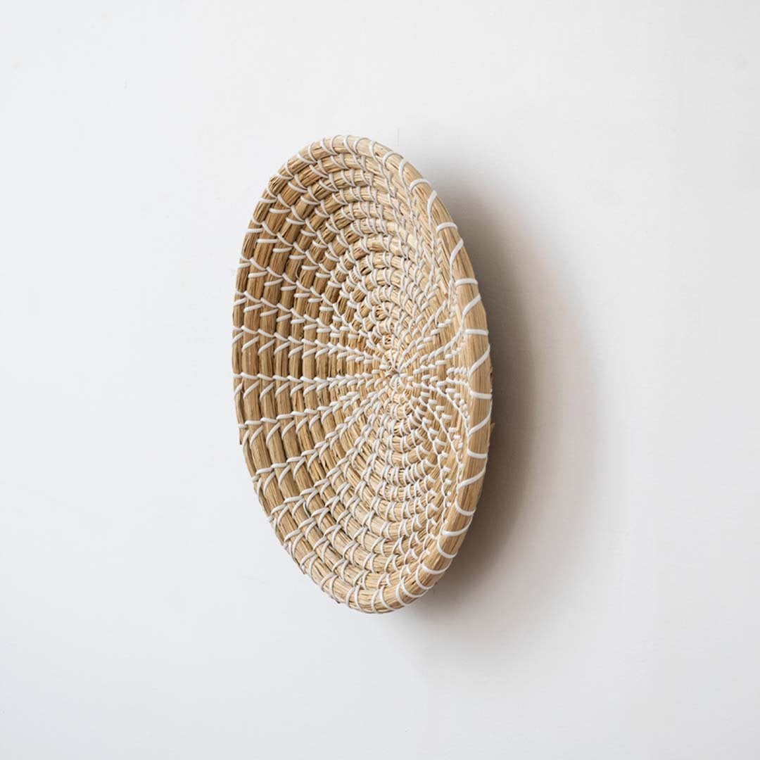 Side view of handwoven wicker basket wall decor showing woven depth and natural texture for modern boho interiors.